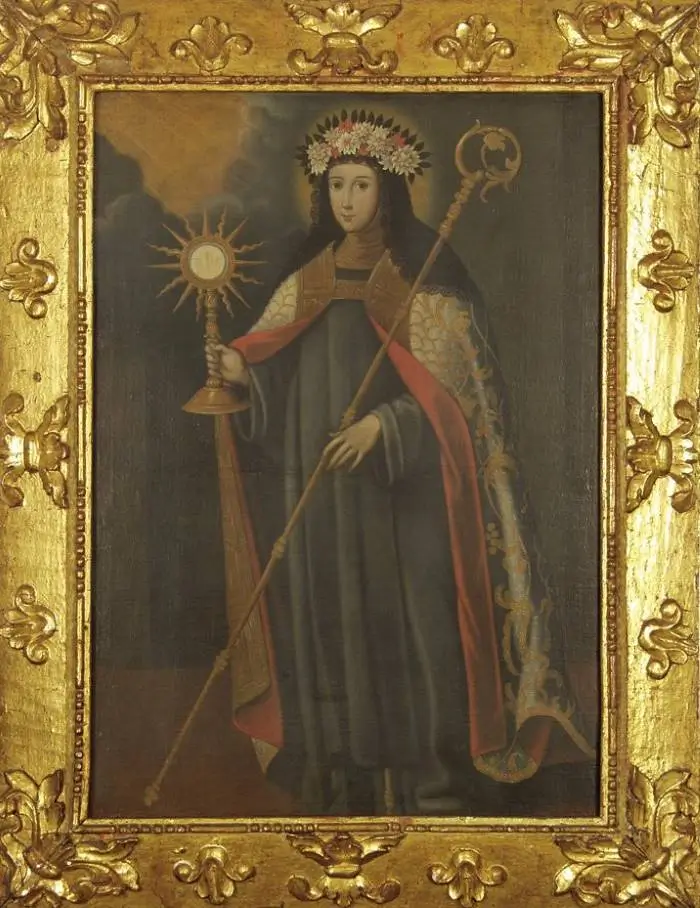 La imagen es un retrato de Santa Clara de Asís, una religiosa italiana y seguidora de San Francisco de Asís. vistiendo hábito franciscano ceñido con un cordón de tres nudos. En su mano derecha sostiene una custodia y en la izquierda el báculo de abadesa.
